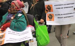 Marchers holding signs at the Toronto Disability Pride March